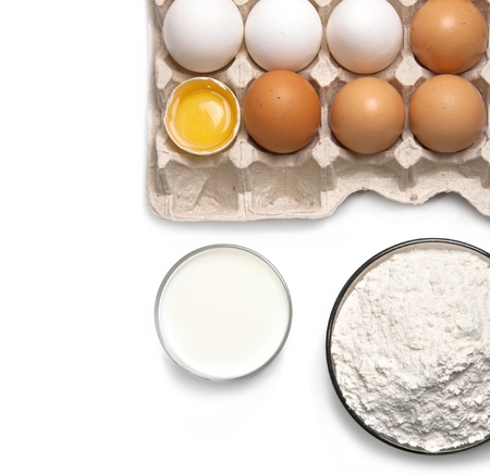 Eggs, glass of milk and flour isolated on white backgroundの写真素材