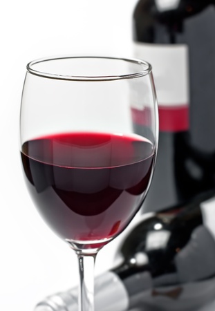 Red wine in glass and bottles, isolated, wihite backgroundの写真素材