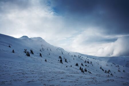 Mountain hill covered with snow, winter landscapeの写真素材