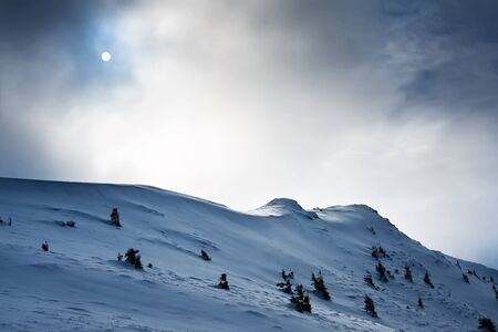 Mountain hill covered with snow, winter landscapeの写真素材