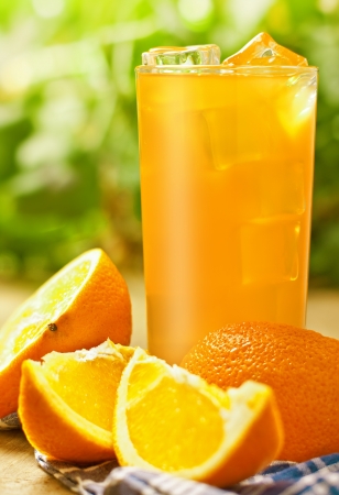 Orange juice on the wood surface, outdoorの写真素材