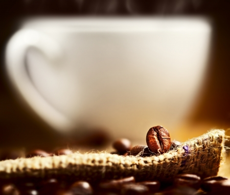 Coffee beans and cup on backgroundの写真素材