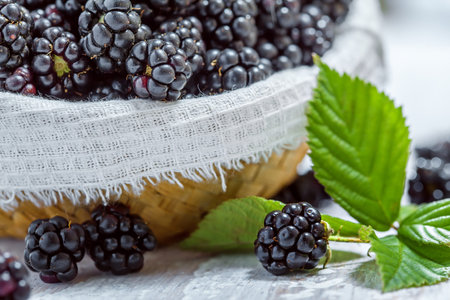 Blackberries on white wooden table, close-up