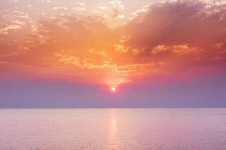 Sunset sky above sea, sunrise landscapeの写真素材