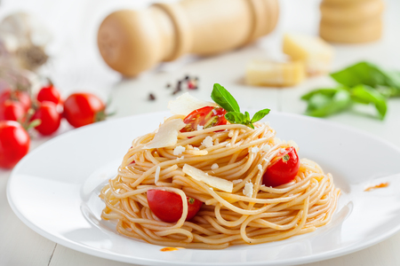Spaghetti with tomato sauce, parmesan cheese and basil, delicious Italian foodの写真素材
