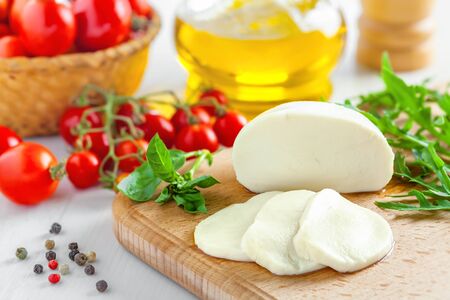Mozzarella with tomatoes and arugula, caprese salad cookingの写真素材