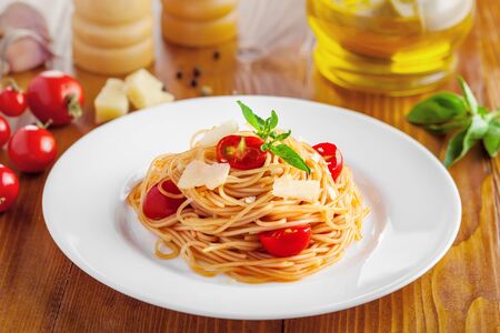 Pasta in tomato sauce with parmesan cheese and basilの写真素材