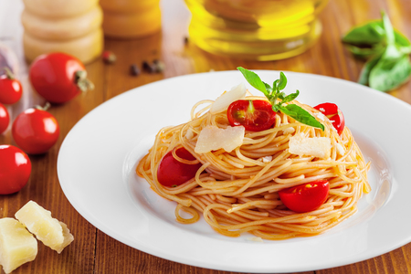 Italian pasta, spaghetti with tomato, parmesan and basilの写真素材