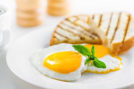 Fried eggs with toasts. Traditional food for breakfast.の写真素材