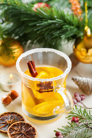 Mulled cider with fruits and spices for Christmas Eve party by tree with decorations. Top view.の写真素材