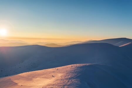 Sunset in mountains. Winter evening landscape.の写真素材