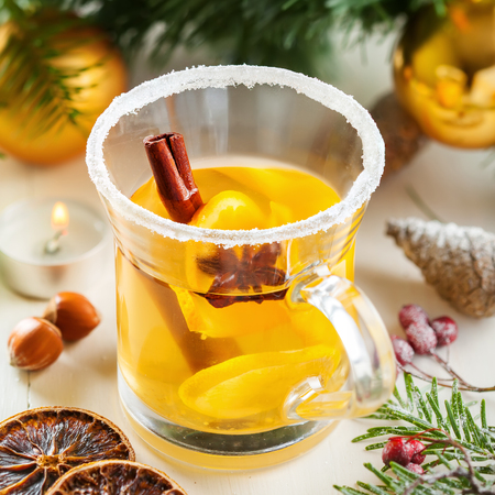 Mulled cider with fruits and spices for Christmas Eve party by tree with decorations. Top view.の写真素材