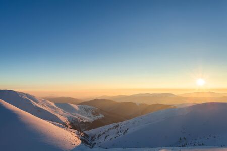 Sunset landscape. Evening glow in winter mountains.の写真素材