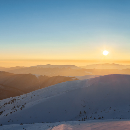 Sunset in winter mountains. Sunny landscape.の写真素材