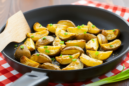 Tasty crispy potato wedges on a pan, vegetarian healthy foodの写真素材