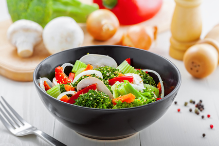 Healthy vegetable salad made of steamed broccoli, onion, mushroom, carrot and pepper. Vegetarian food.の写真素材