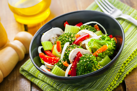 Healthy food made of broccoli, onion, mushroom, carrot and pepper. Vegetarian salad.の写真素材