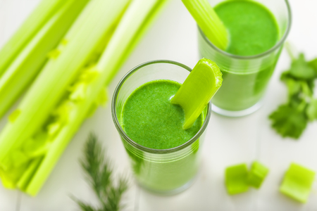 Healthy green smoothie on table, celery and broccoli juice mix, top viewの写真素材