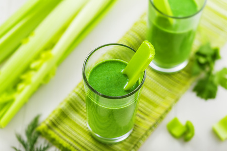 Green smoothie on table, mix of celery and broccoli, top viewの写真素材
