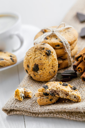 Cookies with chocolate on a table for dessert. Fresh biscuits with coffee for breakfast. Close-up.の写真素材