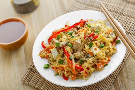 Asian food. Fried rice noodles with tofu, vegetables and shiitake mushroom. Close-up.の写真素材