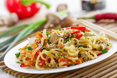 Stirred rice noodles with vegetables, tofu and shiitake mushroom.の写真素材