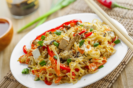 Oriental food made of rice noodles, tofu, vegetables and shiitake mushrooms. Close-up shot.の写真素材