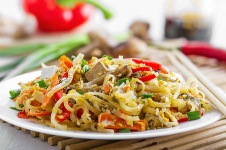 Asian food. Fried rice noodles with tofu, vegetables and shiitake mushroom.の写真素材