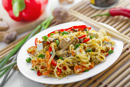 Asian meal made of rice noodles, tofu, vegetables and shiitake mushrooms. Traditional Oriental cuisine meal.の写真素材