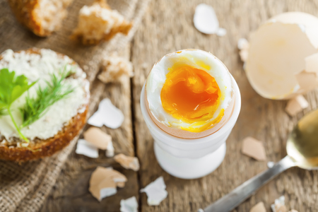Traditional breakfast with perfect soft boiled egg and sandwich with butter and dill. International cuisine food. Top view.の写真素材