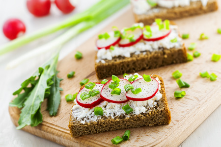 Delicious sandwiches with soft cream cheese and radish.  Vegetarian food.の写真素材