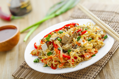 Asian meal made of rice noodles, tofu, vegetables and shiitake mushrooms. Traditional Oriental cuisine meal.の写真素材