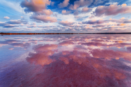 Sunset sky with clouds above salt lake. Beautiful landscape.の写真素材