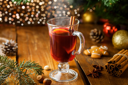 Mulled wine for Christmas Eve celebration party by Christmas tree. Hot traditional winter drink for New Year eve.の写真素材