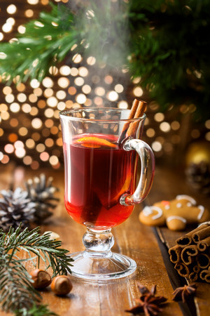 Glass of mulled wine with citrus fruits and cinnamon. Christmas holiday drink.の写真素材