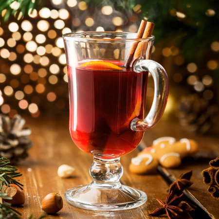 Christmas Eve mulled wine in glass with citrus fruits and spices. Tasty traditional hot drink.の写真素材