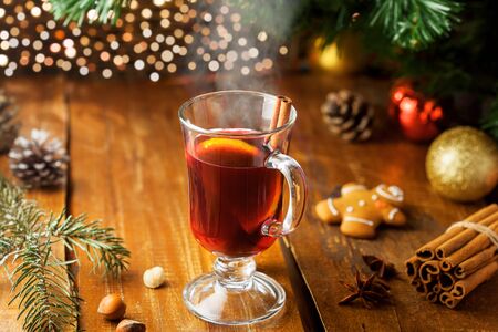 Mulled wine with citrus fruits and cinnamon on a table. Traditional winter hot drink for Christmas Eve party.の写真素材