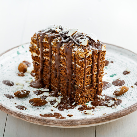 Beautiful dessert on a table. Delicious chocolate Spartak cake served on a beautiful rustic plate. International haute cuisine dessert.の写真素材