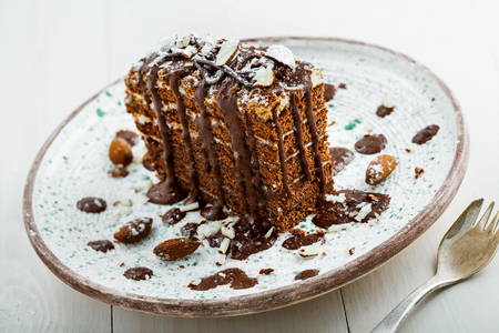 Tasty piece of chocolate Spartak cake on a rustic plate. Traditional delicious dessert on a table.の写真素材