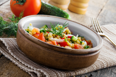Delicious Israeli couscous Ptitim with vegetables on a table. Healthy vegetarian food for the meal. Traditional Moroccan cuisine.の写真素材