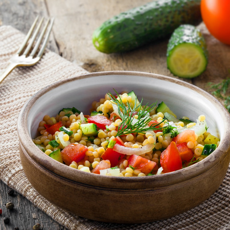 Delicious Israeli couscous Ptitim with vegetables on a table. Healthy vegetarian food for the meal. Traditional Moroccan cuisine.の写真素材