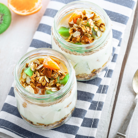 Granola with yogurt and fruits in a rustic jar Delicious healthy American food for breakfast Traditional US snack Top viewの写真素材