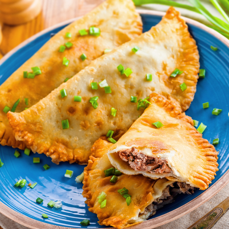 Russian, Turkish, Ukrainian and Tatar national meal cheburek. Traditional east cuisine food. Meat pastry on a table. Top view shot.の写真素材