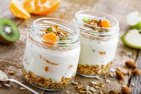 Yogurt, granola and fruits in a jars for delicious breakfast. Traditional American healthy food. Close-up shot.の写真素材