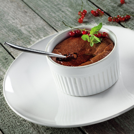 Tasty chocolate mousse on a rustic wooden table. Delicious dessert with liquid chocolate inside. Close-up.の写真素材