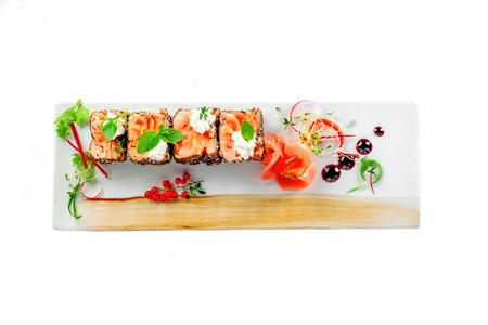 Traditional healthy Japanese meal sashimi made of salmon fish on a square plate. Fish rolls isolated on a white background. Top view.の写真素材