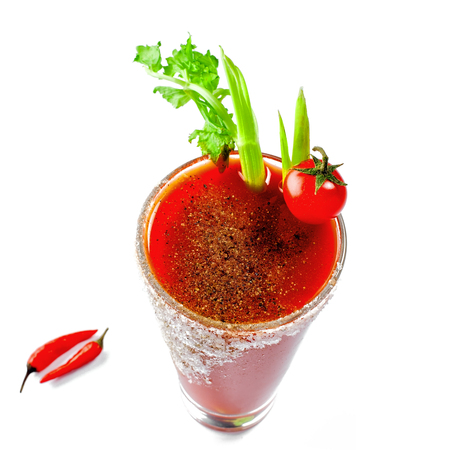 Glass of bloody mary isolated on a white background. Delicious alcohol cocktail made of tomato juice, vodka, pepper, salt, lemon juice, celery and other flavorings.の写真素材