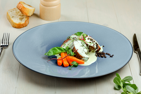Gourmet meat medallions with delicious cream sauce, toasted bread and fresh vegetable salad. Tasty meat meal served on a luxurious plate.の写真素材