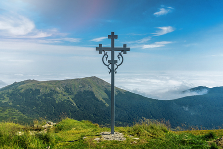 Landscape of Carpathian Mountains in a summer sunny day with. Beautiful mountain scenery with clear sky and a cross.の写真素材