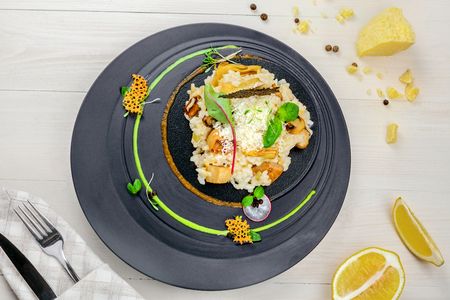 Gourmet Italian risotto cooked in a vegetable broth with porcini mushrooms and parmesan cheese served on an expensive exclusive plate. Directly above top view shot.の写真素材